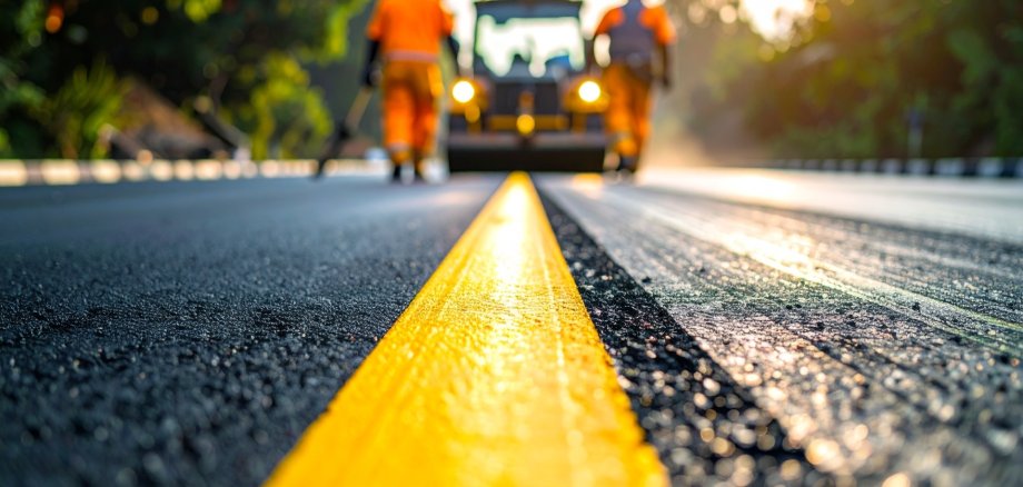 Asphalt Paving and Road Construction Crew, Applying Fresh Asphalt on Rural Highway Asphalt Paving and Road Construction Crew, Applying Fresh Asphalt on Rural Highway