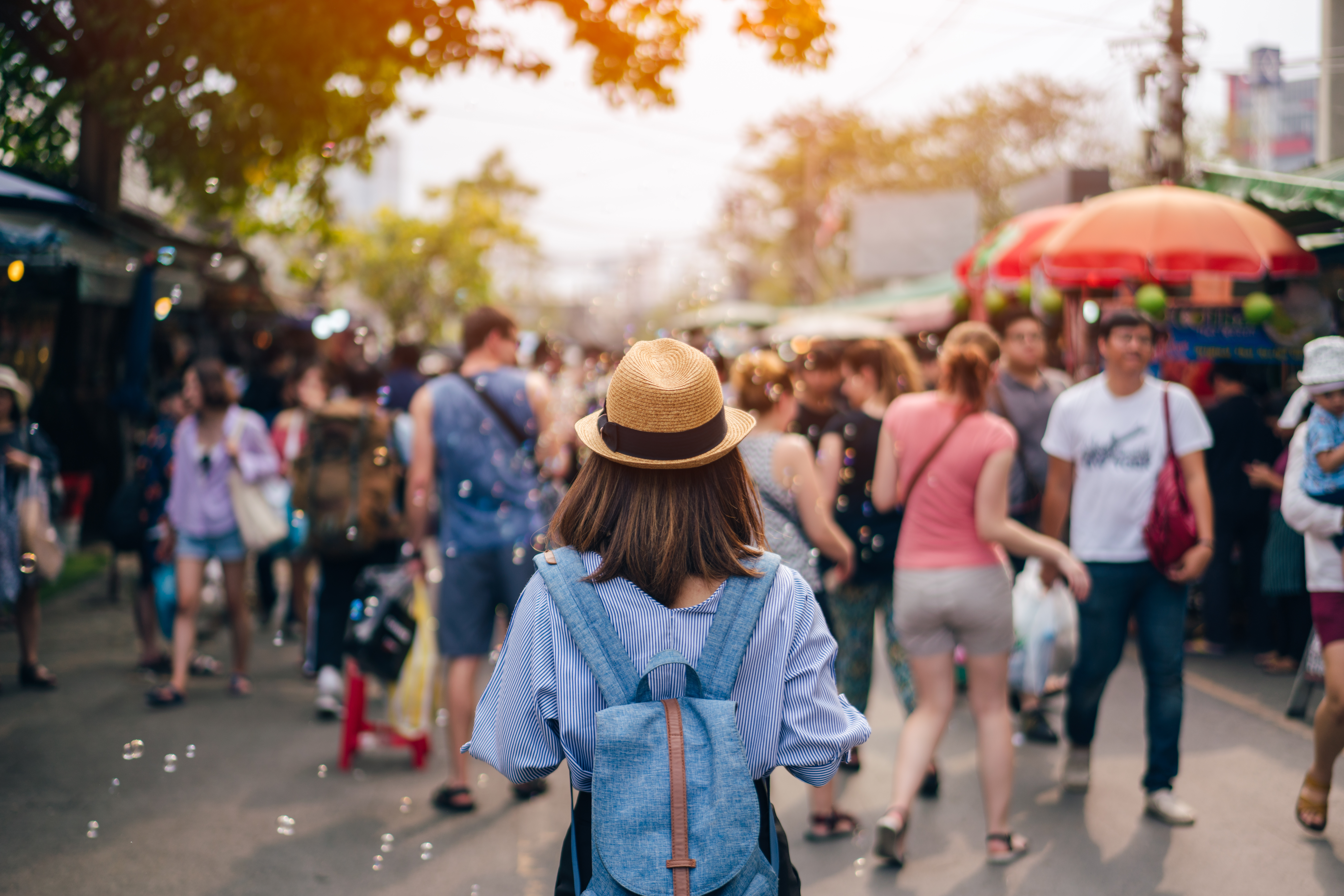 Young woman traveler with sky blue backpack and hat looking the Young woman traveler with sky blue backpack and hat looking the
