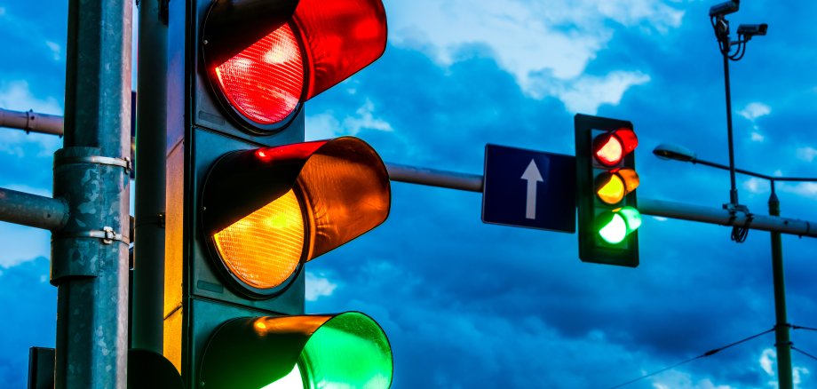 Traffic lights over urban intersection Traffic lights over urban intersection